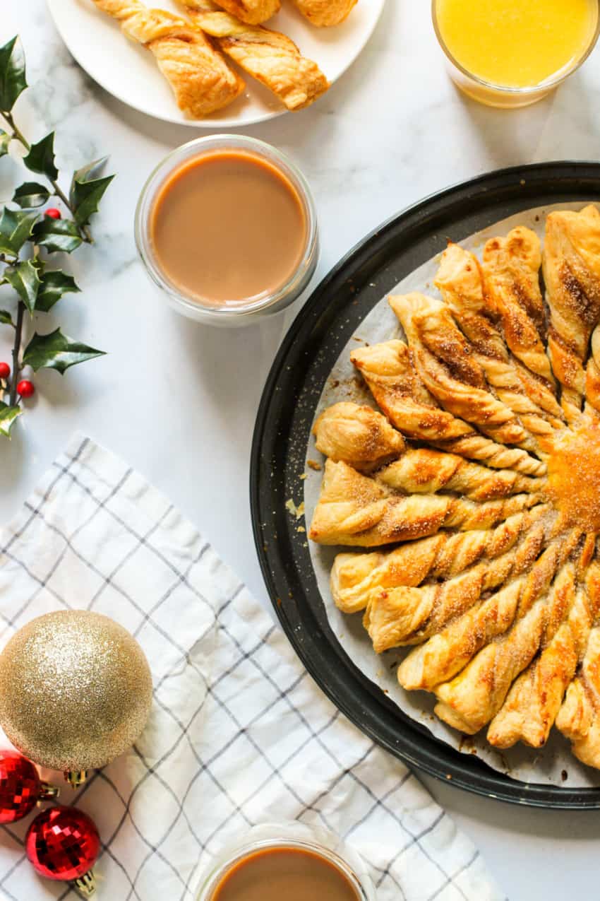 cinnamon sugar khari in a black platter served with tea and orange juice 
