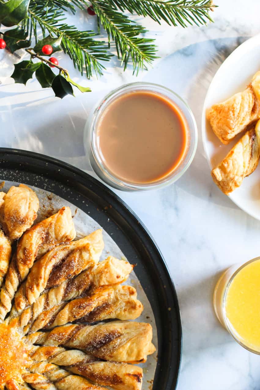 cinnamon sugar khari in a black platter served with tea and orange juice 