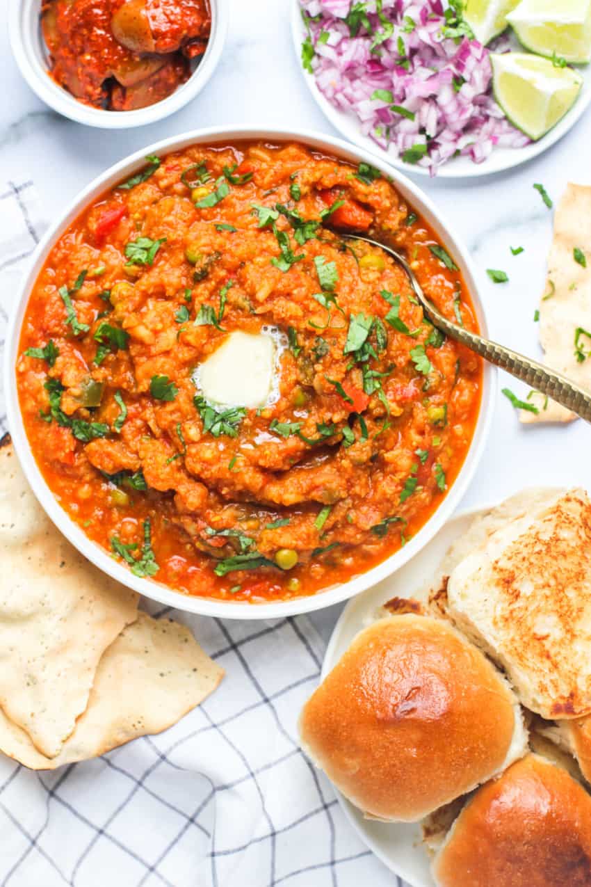 pav bhaji served with diced onions, pickle and papad 