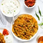 Thalipeeth served with yogurt, pickle and chutney