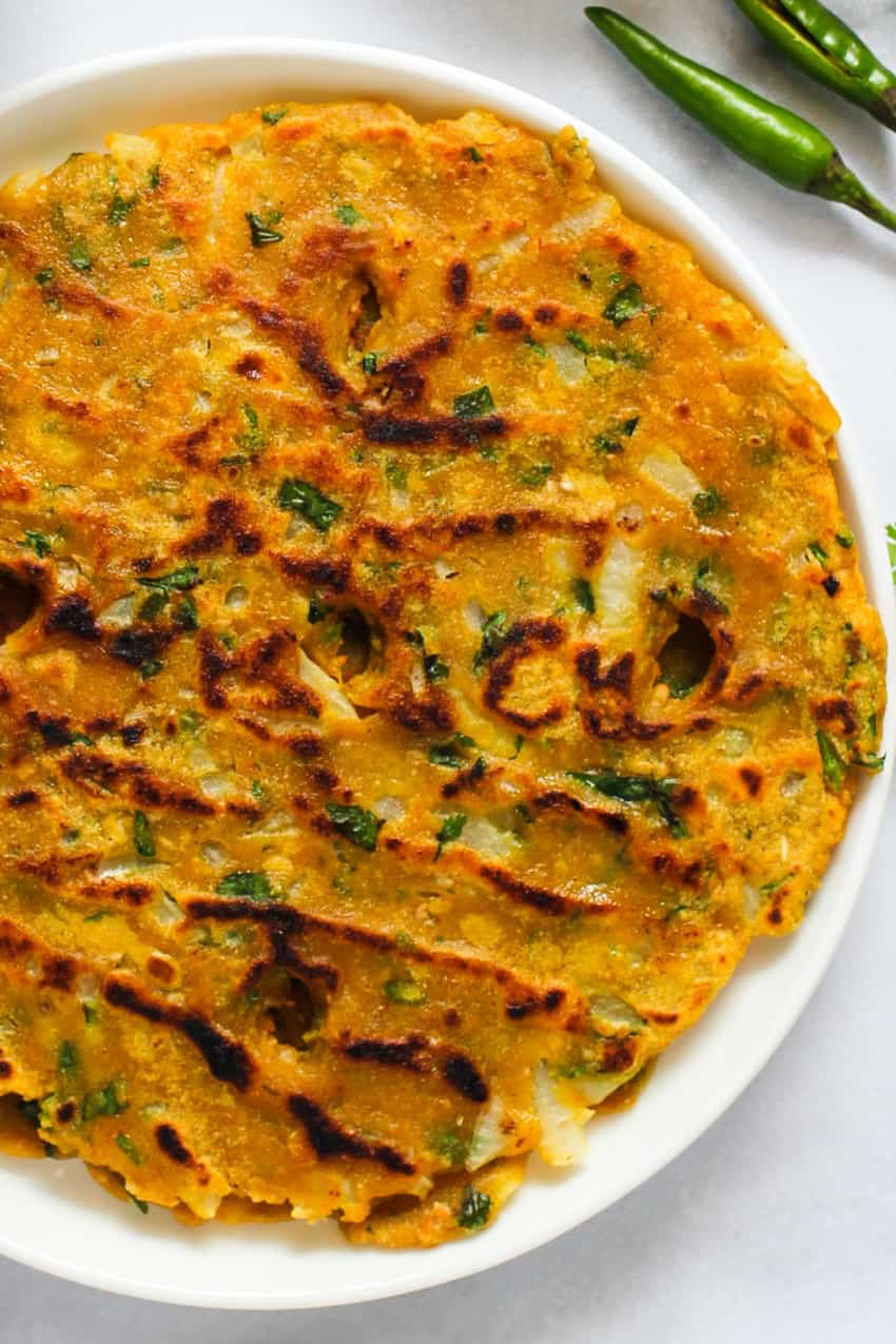 Thalipeeth served in a white plate 