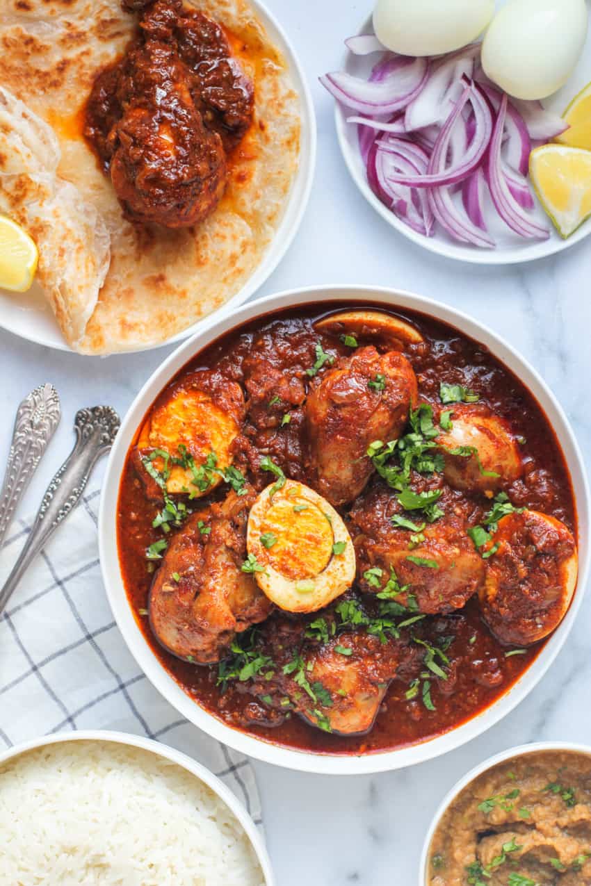 Doro wot served with rice, sliced onions and lemons 
