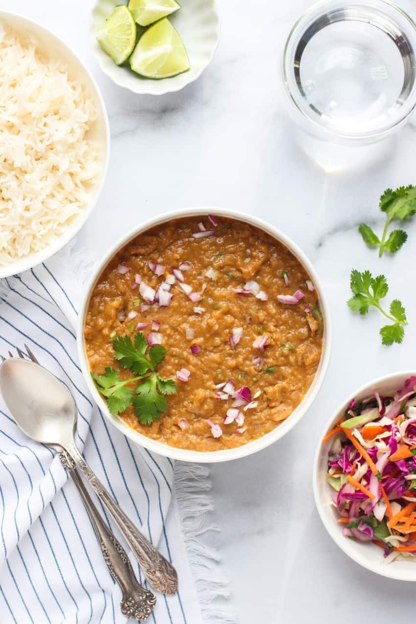 misir wot in a white bowl with white rice on the side