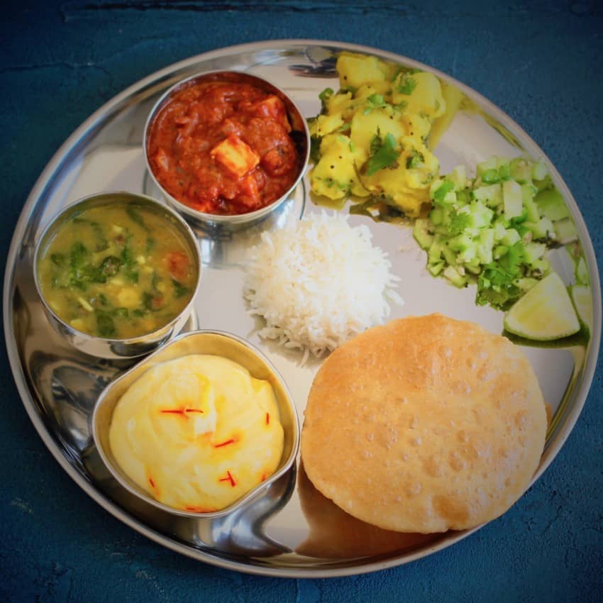 Indian Thali meal with shrikhand and puri 