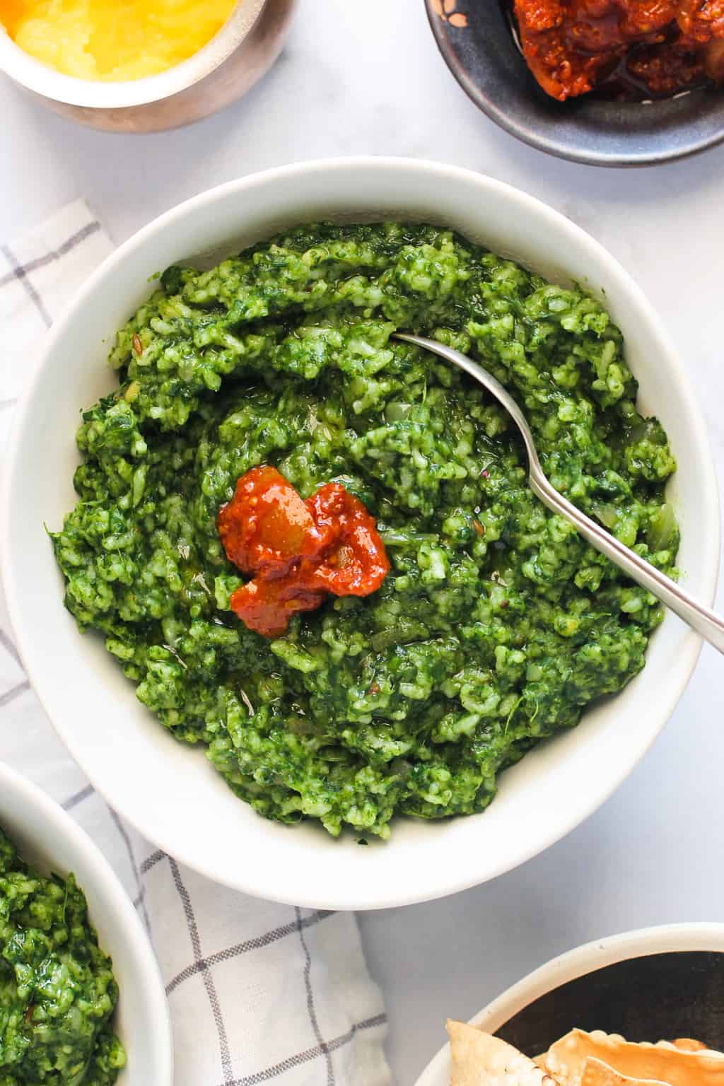spinach khichdi served with pickle on top 