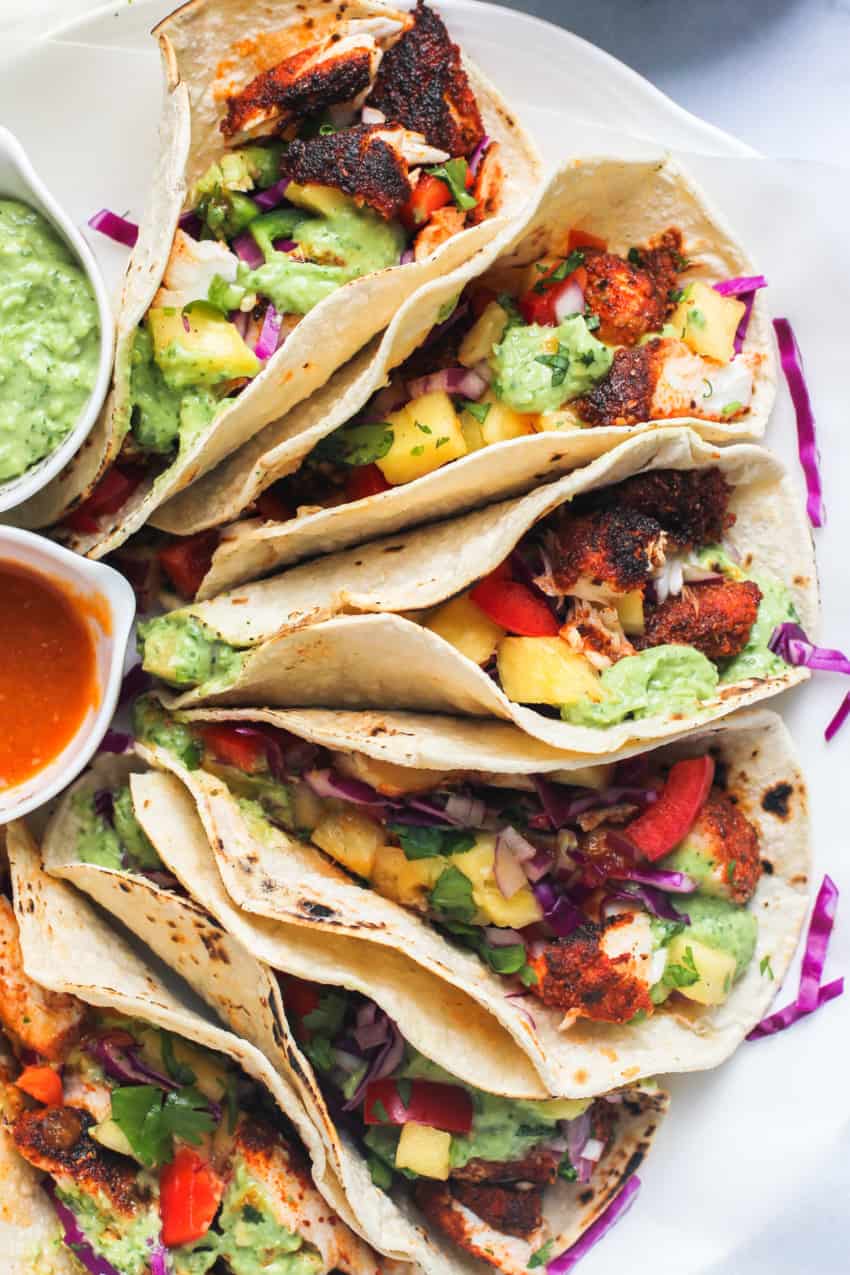 platter of blackened fish tacos with sauces 