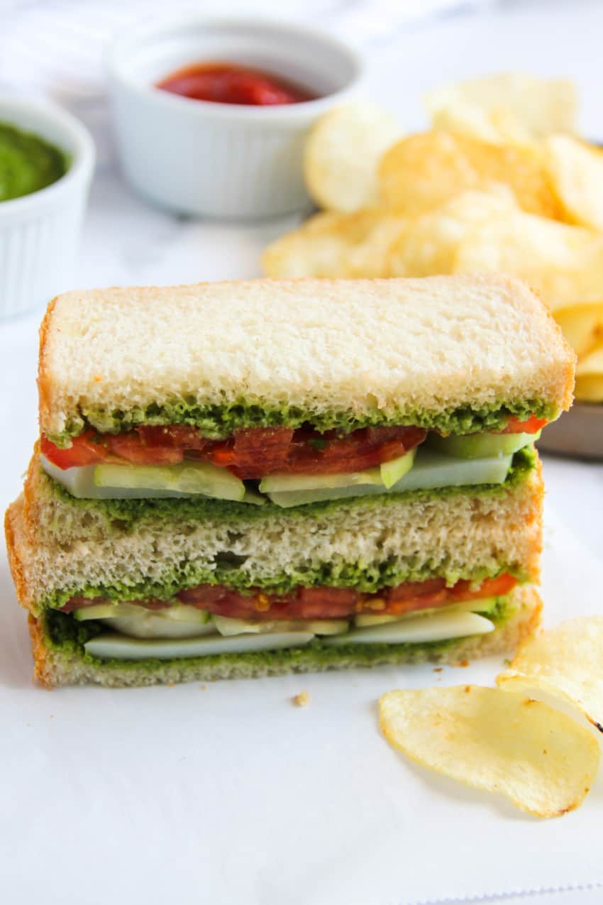 stacked up chutney sandwich  with potato chips