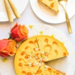 mango cheesecake with a slice served in a plate