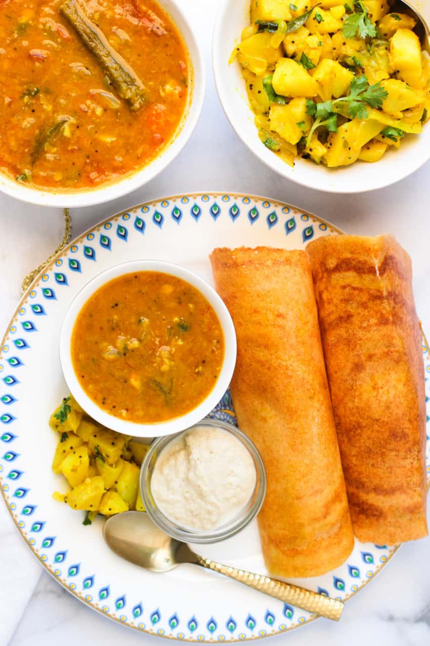 quinoa oats dosa served with sambar, chutney & curried potatoes 