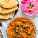 paneer butter masala served with naan and raita