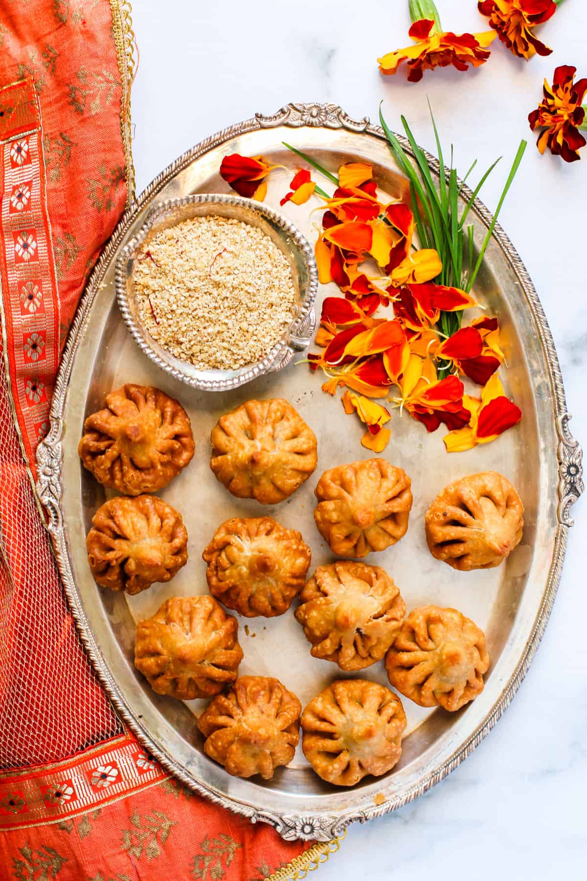 fried modak in a silver platter 