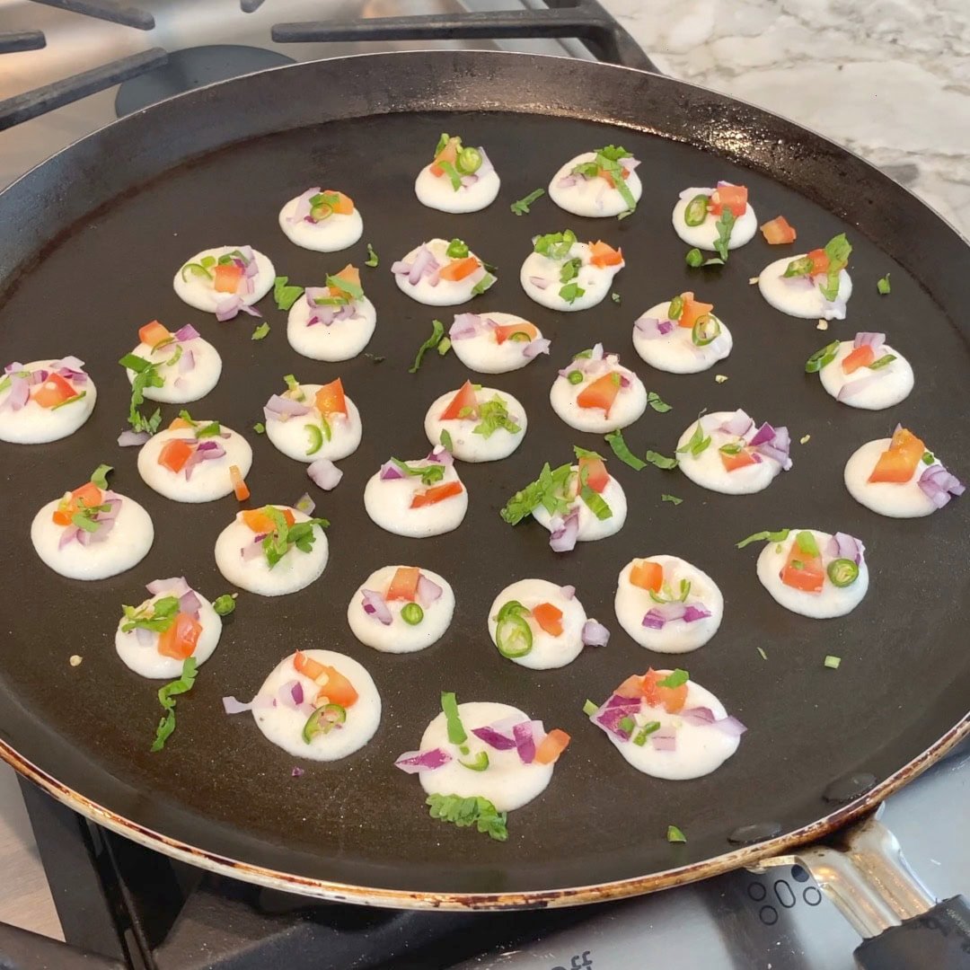 onion, tomato, green chili added to bite sized uttapam