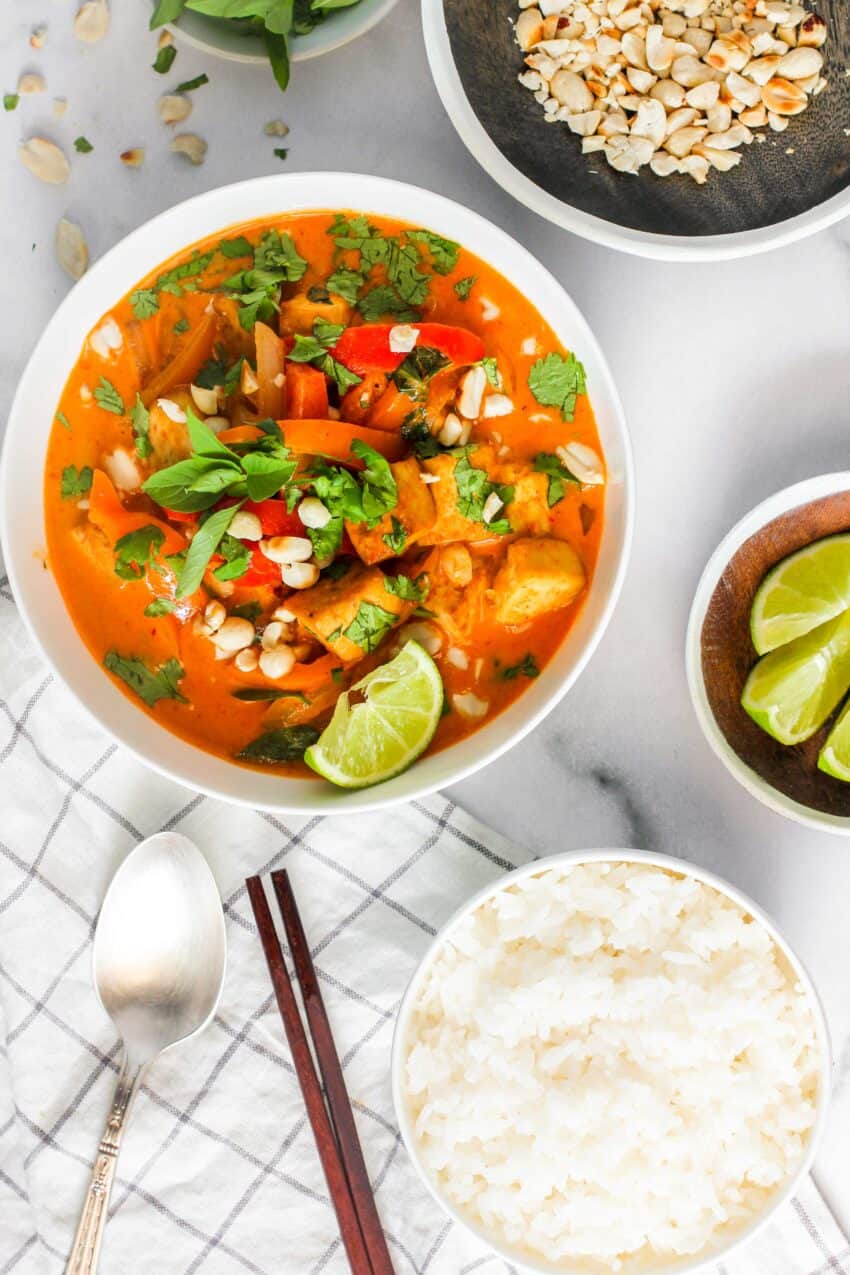 Thai Panang Curry garnished with basil and peanuts served in a white bowl 