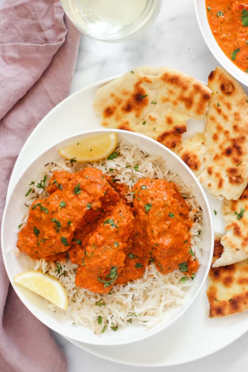 A plate of Salmon Tikka Masala with rice
