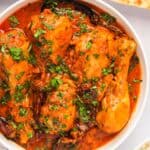 Achari Chicken Curry served in a white bowl