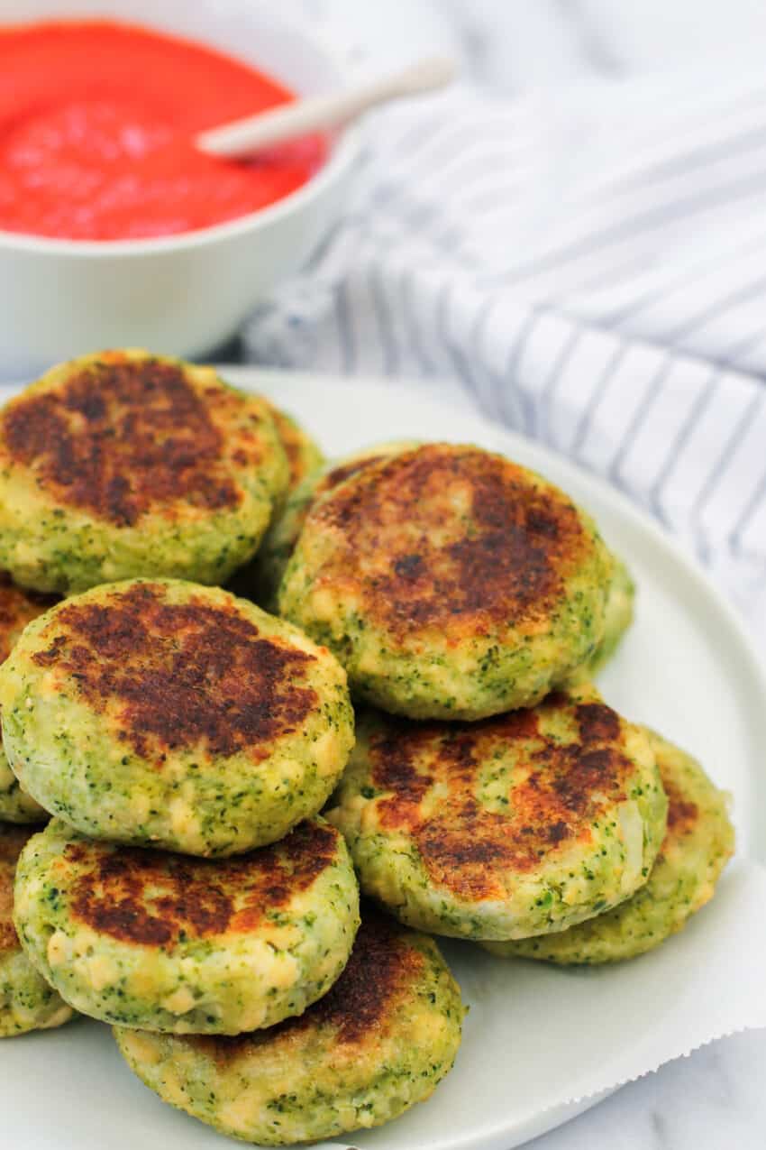 broccoli and tofu patties stacked on white plate