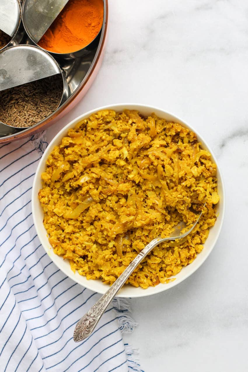 Cumin cauliflower rice served in a white bowl.
