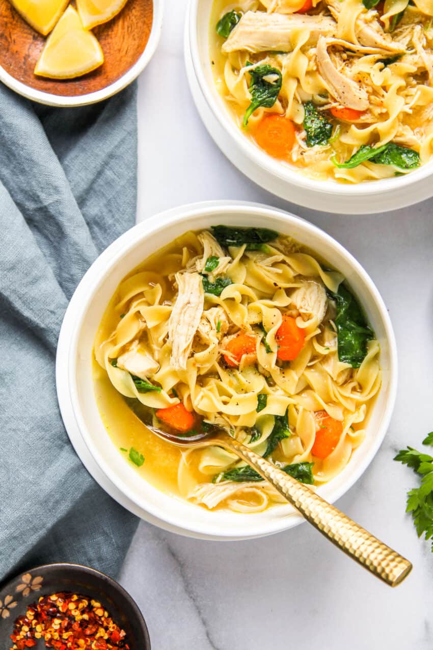 2 bowls of chicken noodle soup with kale