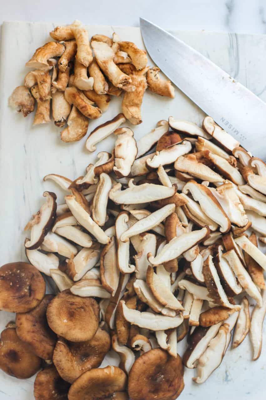 Sliced shiitake mushrooms on a cutting board 
