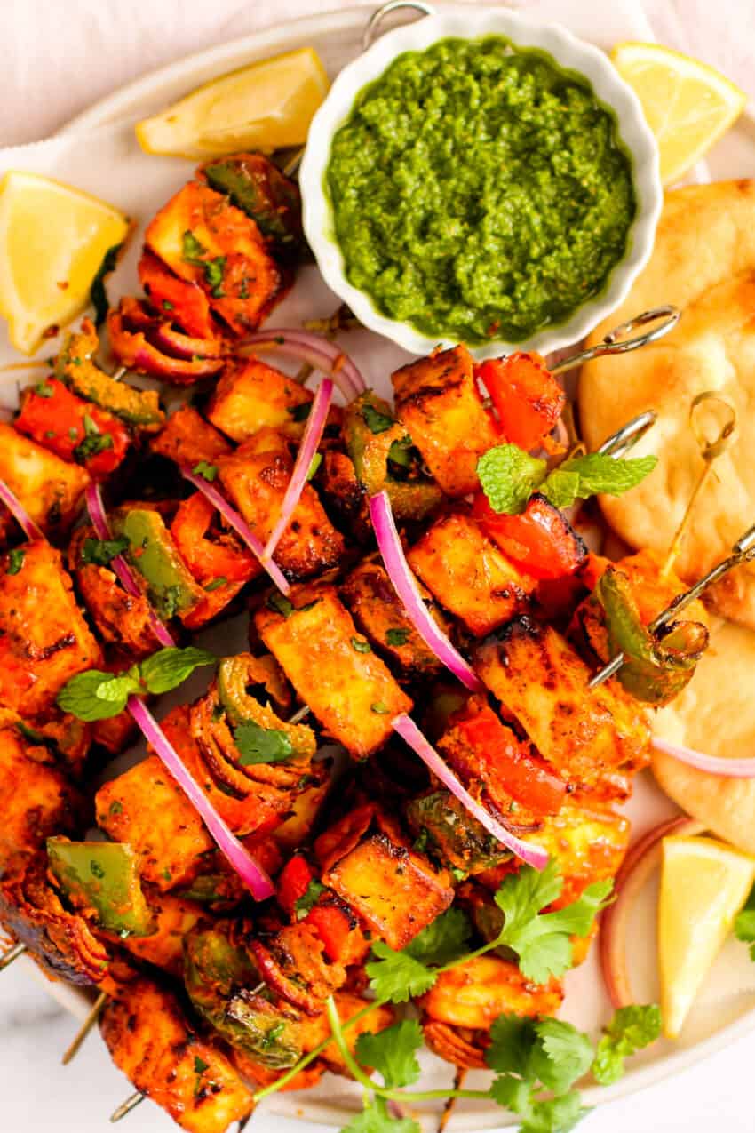 paneer tikka skewers served with chutney 