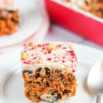 carrot cake with frosting served in a white plate