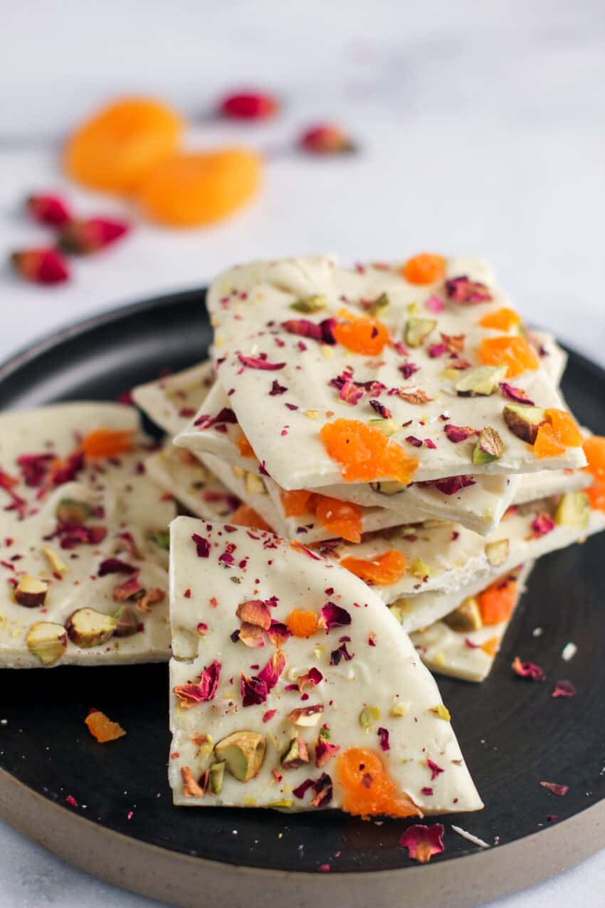 white chocolate bark stacked in a black plate 