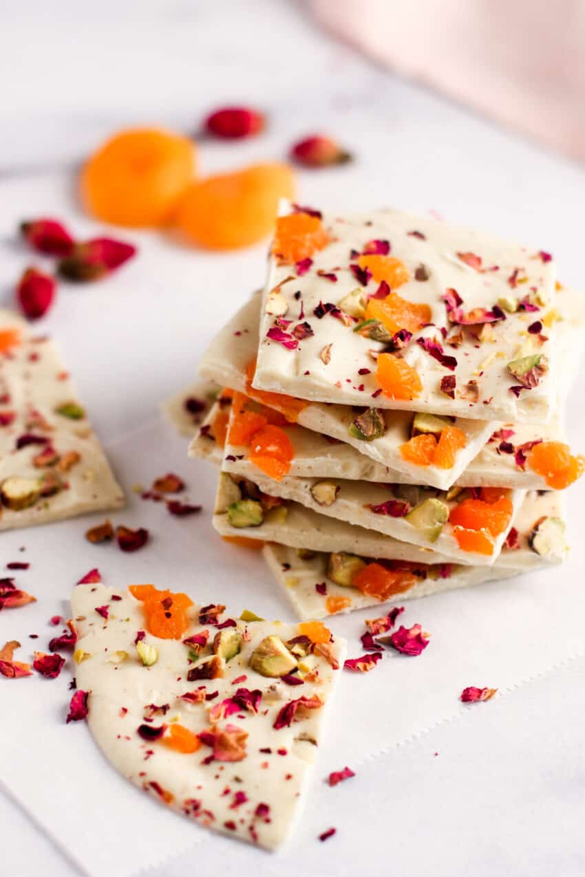 white chocolate bark with pistachios, apricots and rose petals on parchment paper