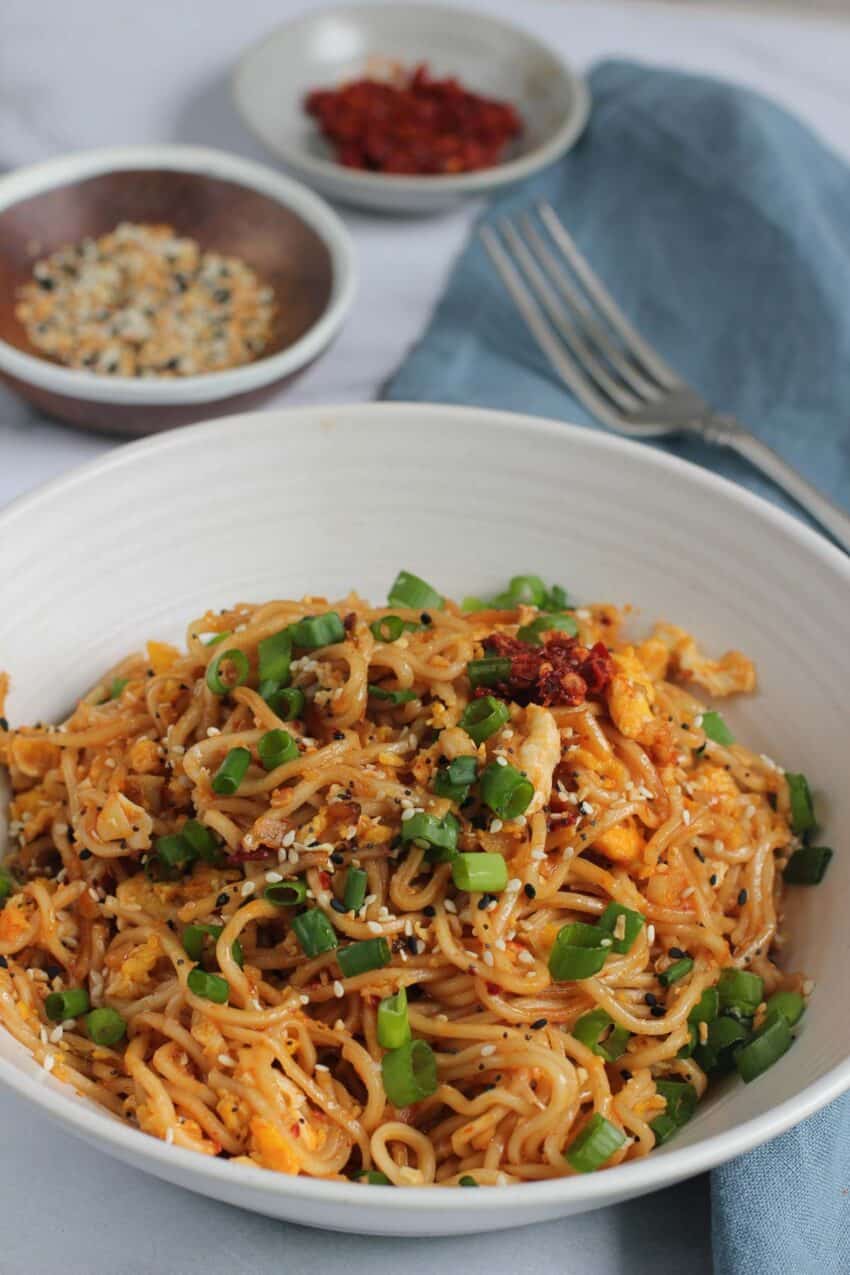 Ramen Noodles in a bowl garnished with scallions and sesame seeds 