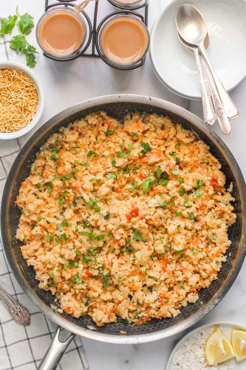 upma in a skillet with tea cups 
