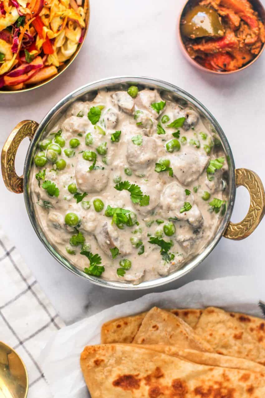 mushroom matar malai served with paratha, pickle and cabbage salad