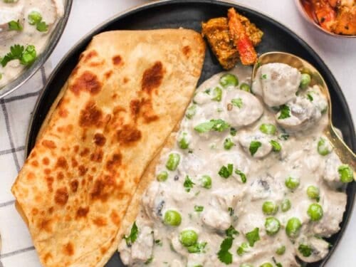mushroom matar malai served with paratha, rice and cabbage salad
