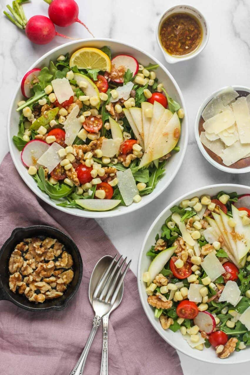 Arugula salad in white bowls 