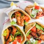 stack of chicken shawarma rolled in pita