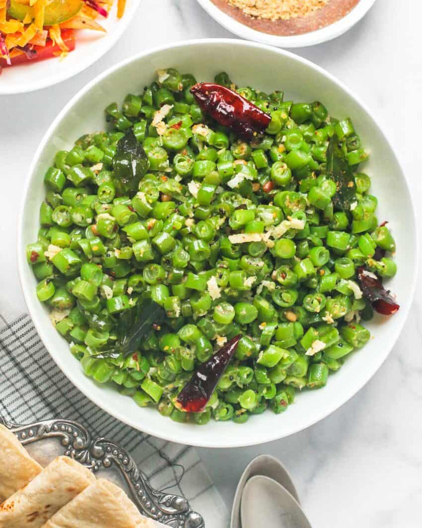 White bowl with green beans poriyal