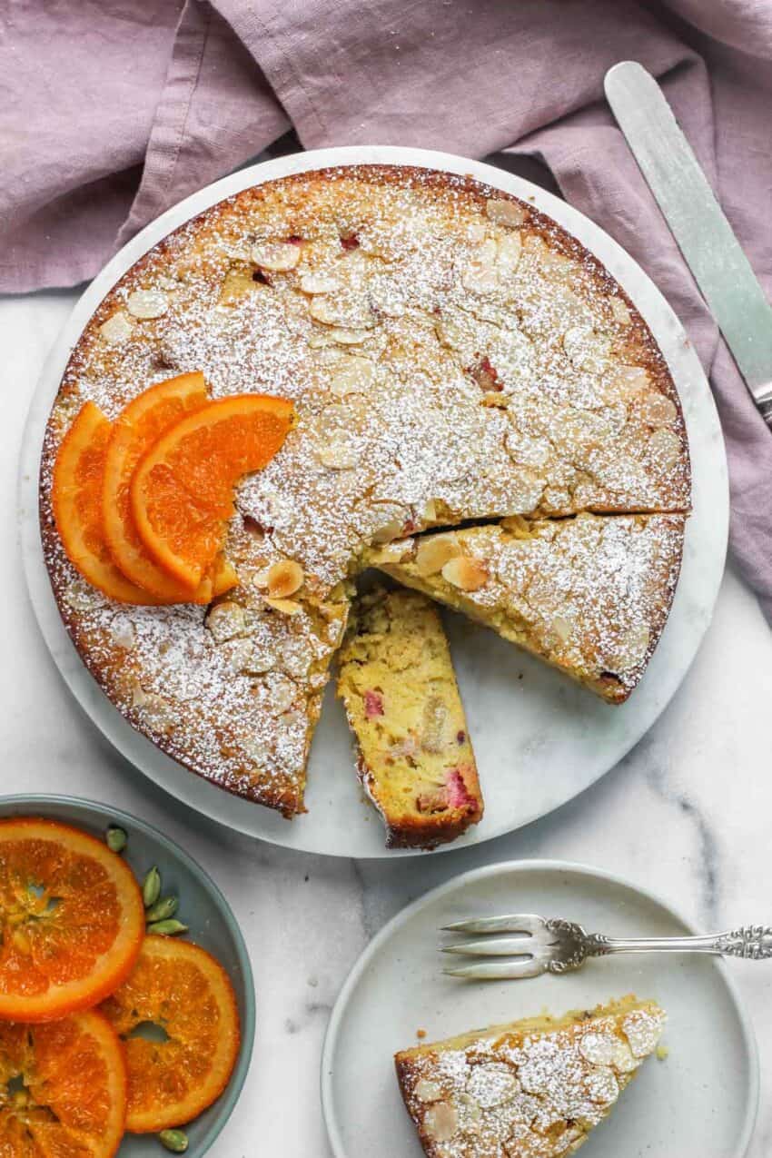 rhubarb cake with powdered sugar and candied orange slices