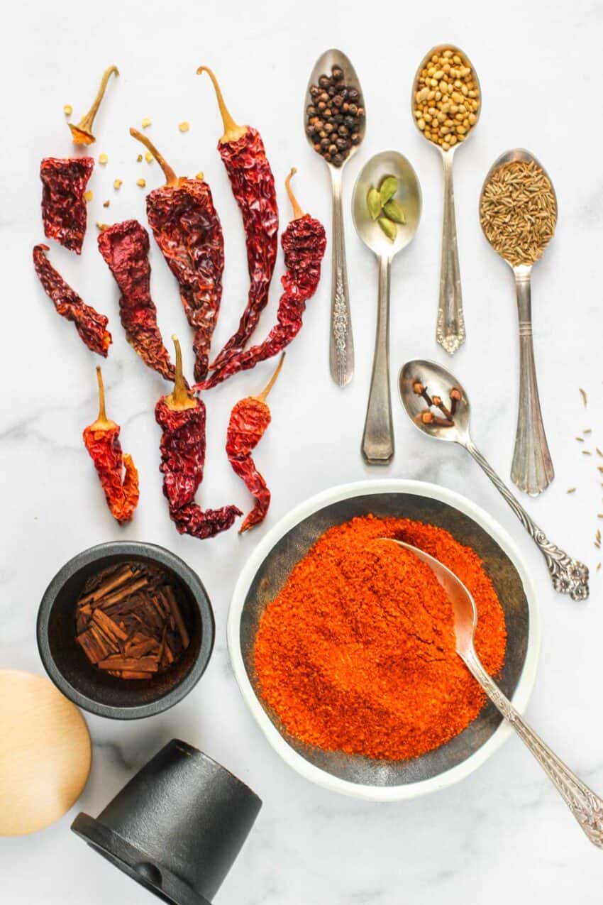 vindaloo spice mix in a bowl along side whole spices