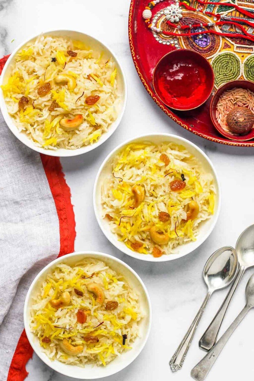 sweet coconut rice served in 3 white bowls with rakhi thali 