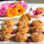 Badushah garnished with pistachios and rose petals