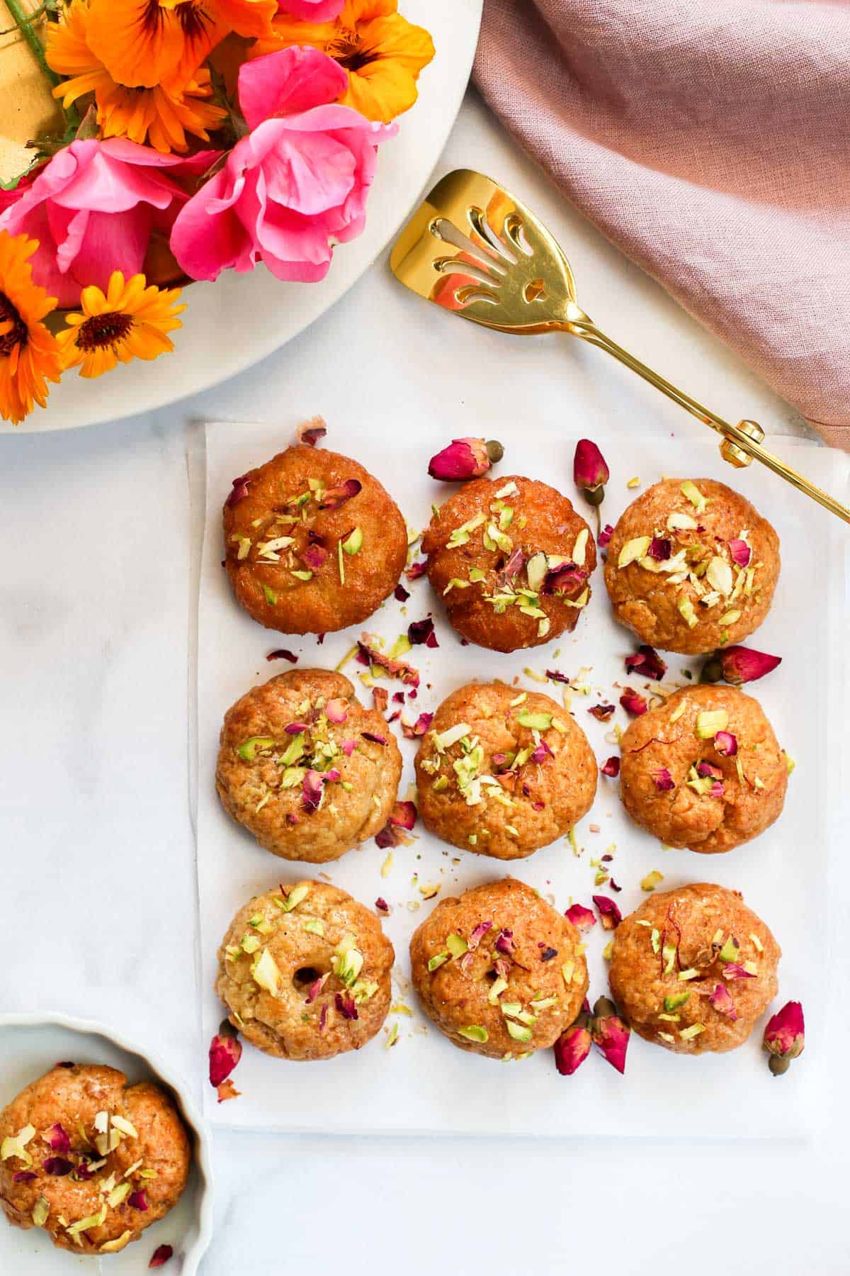 Air Fried Balushahi garnished with pistachios and dried rose petals 