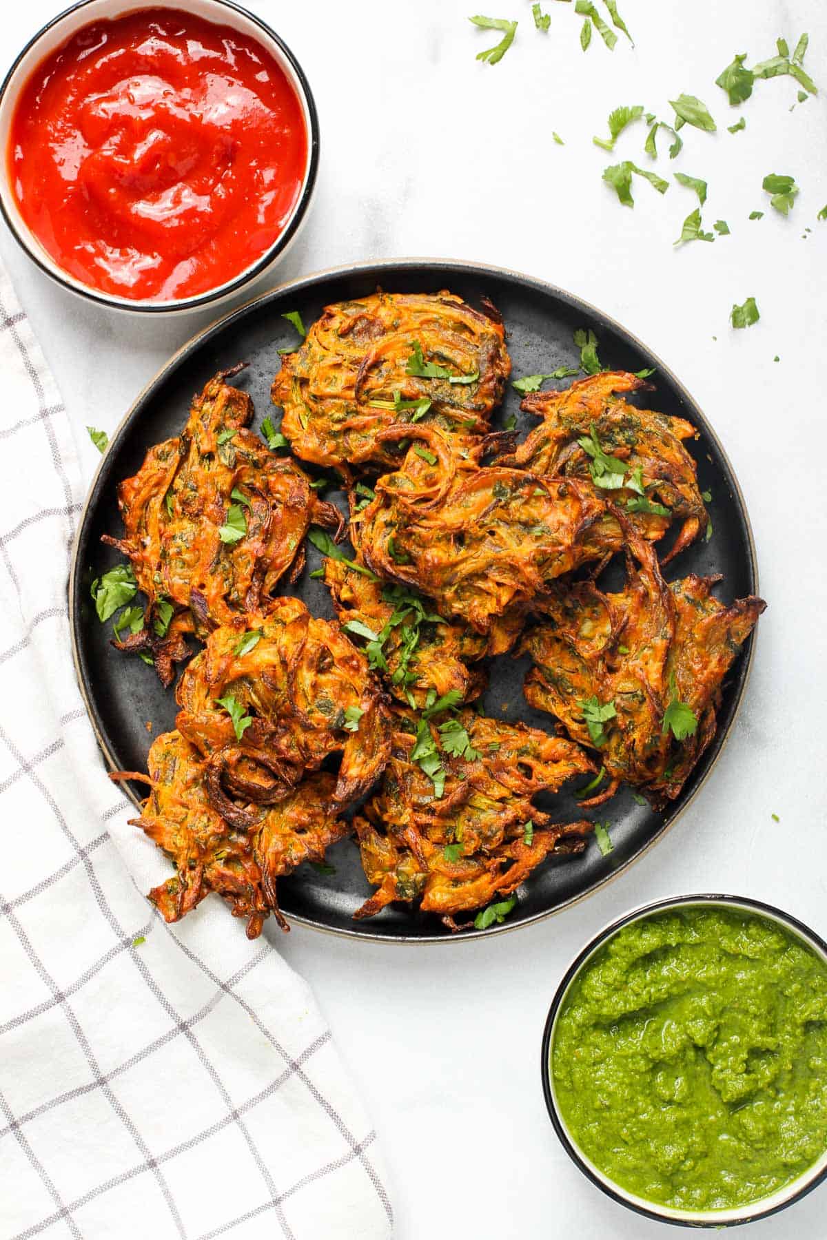 Onion pakodas served with ketchup and chutney