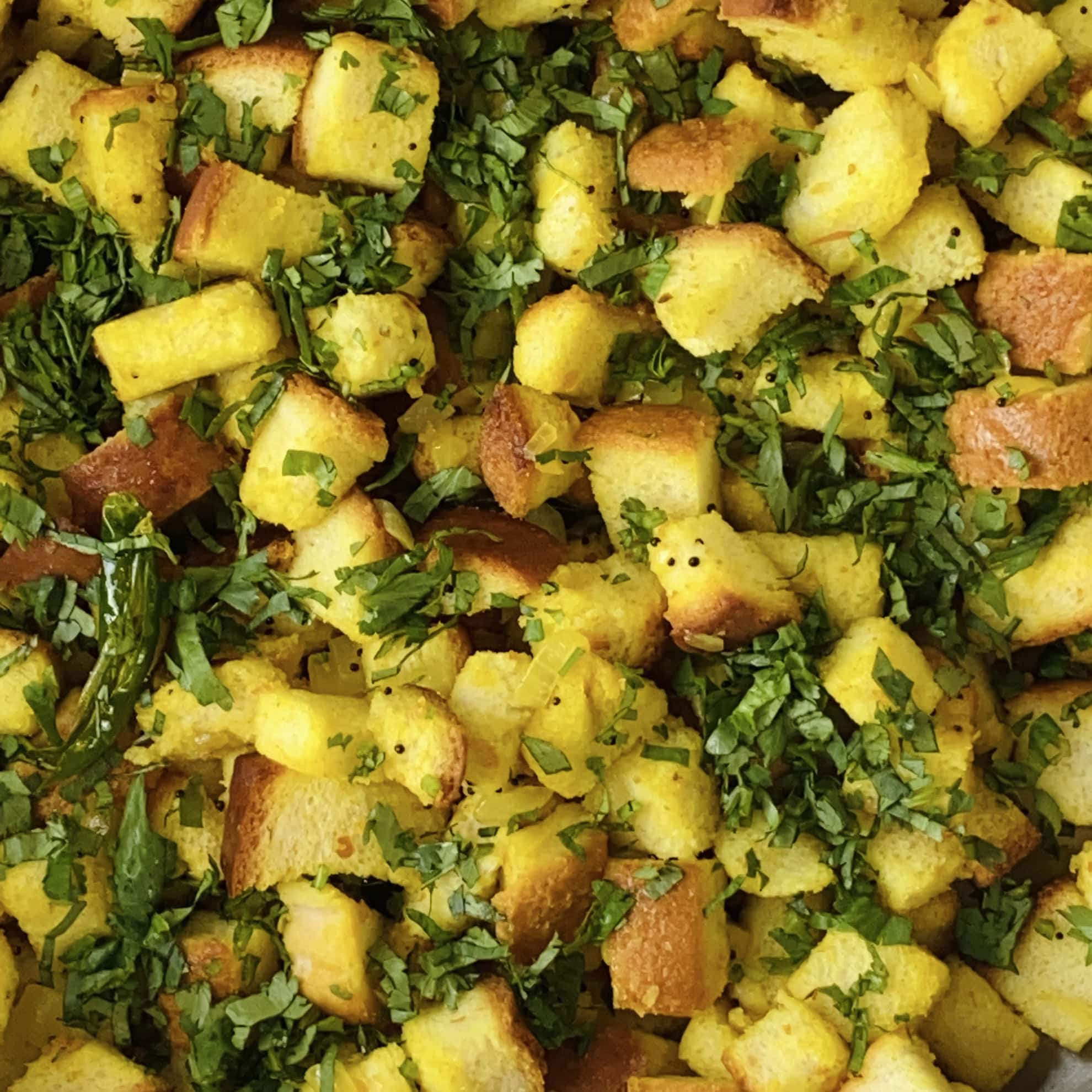 bread upma garnished with cilantro.