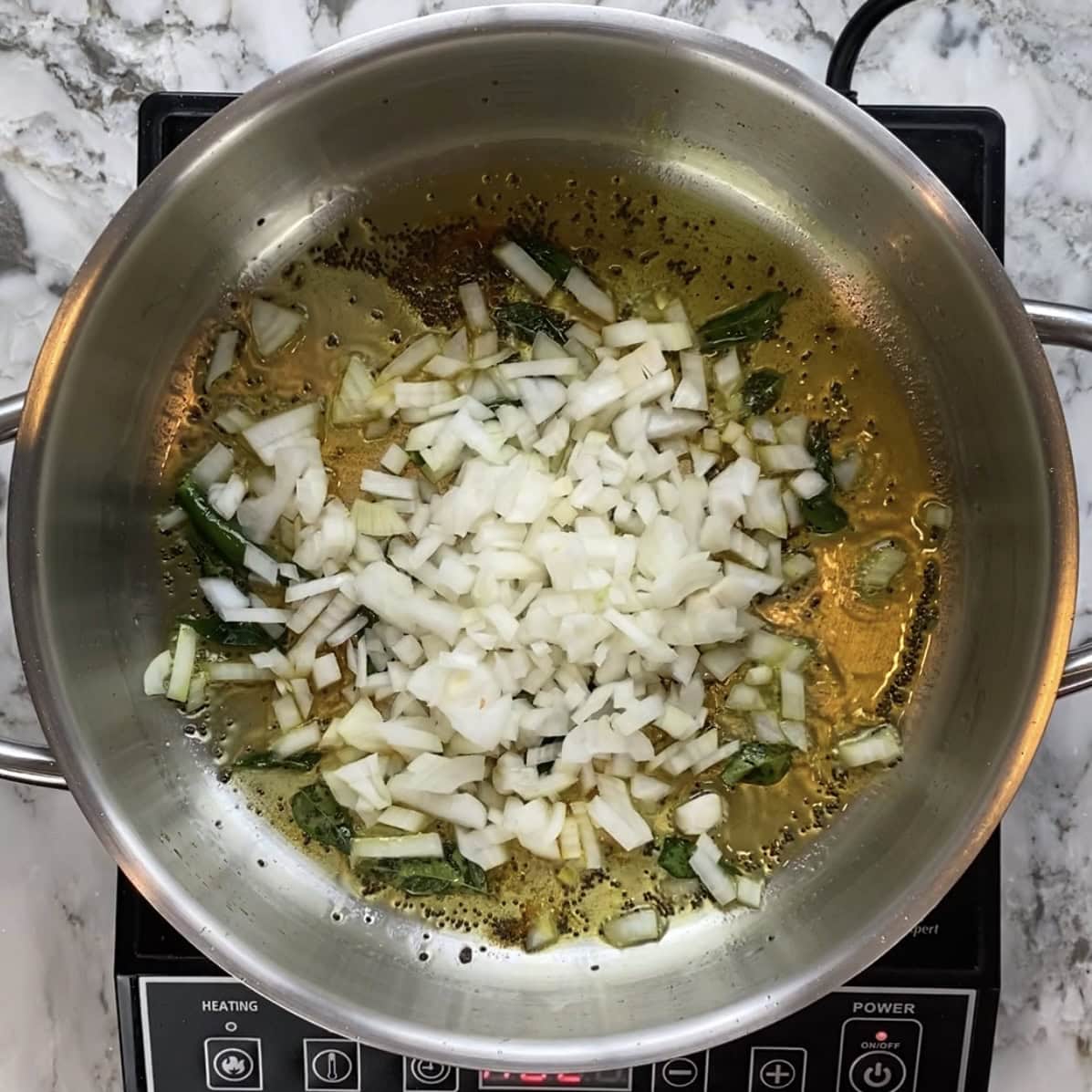 diced onions added to the pan with tadka.
