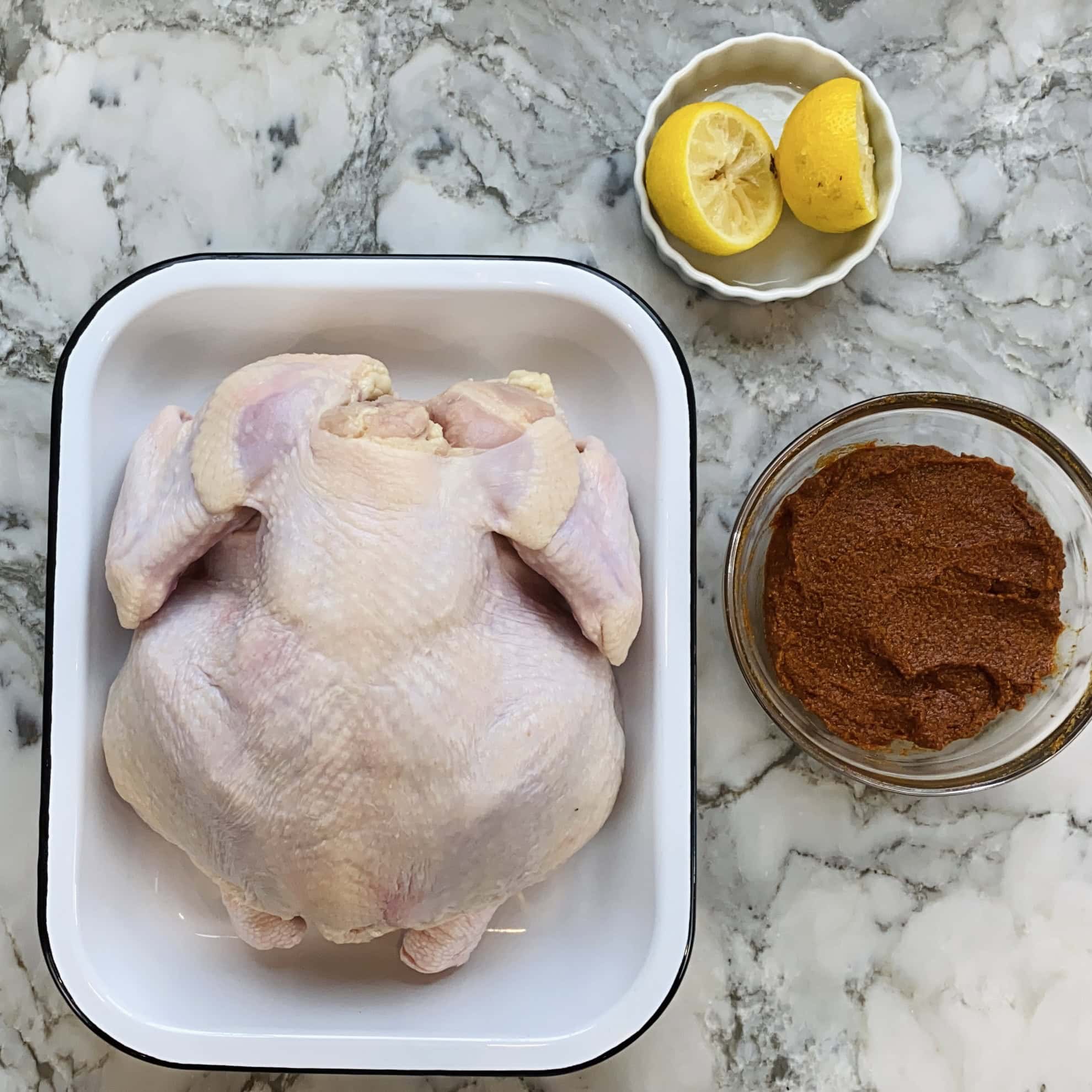 prepped whole chicken in a tray