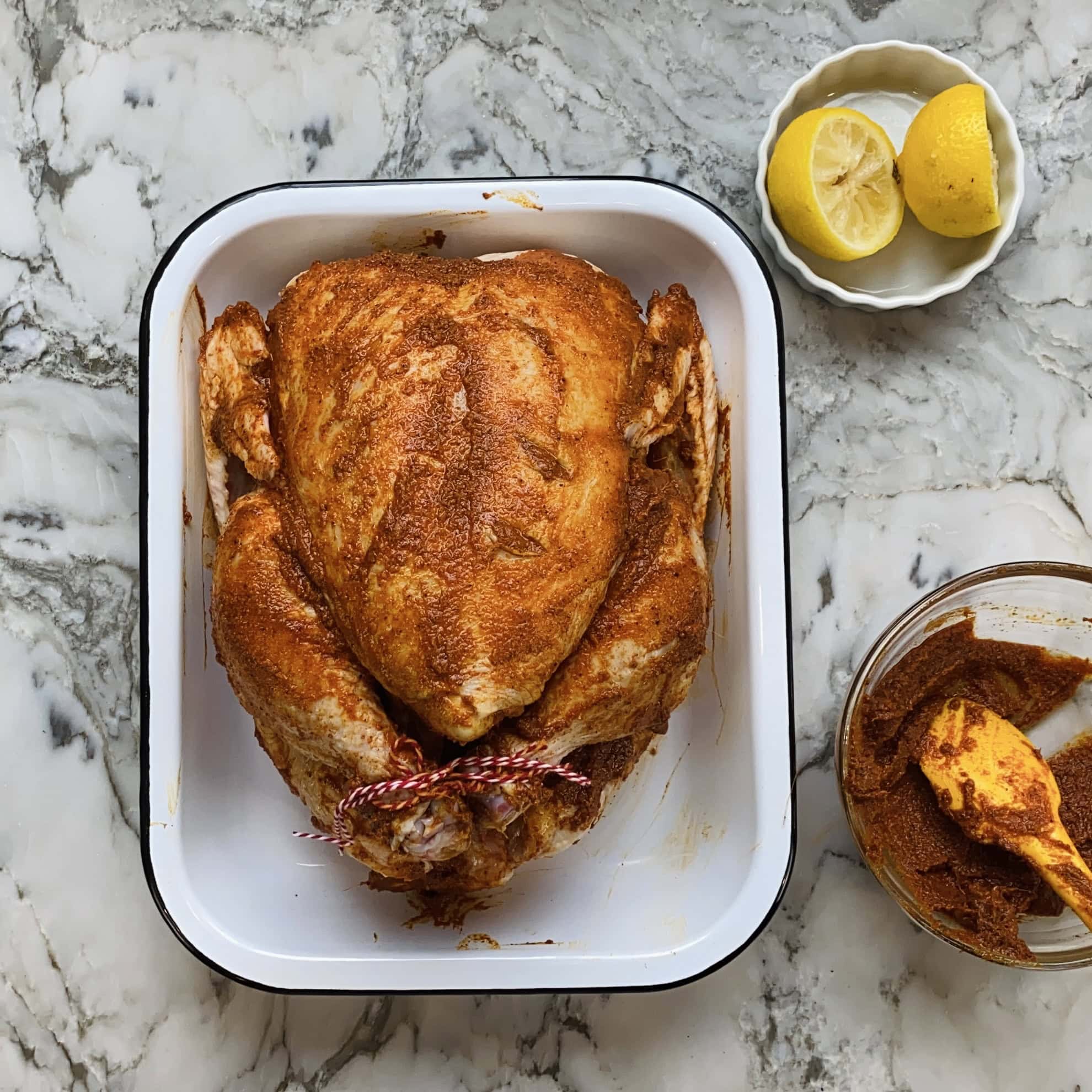marinated whole chicken with legs tied with cooking wine.