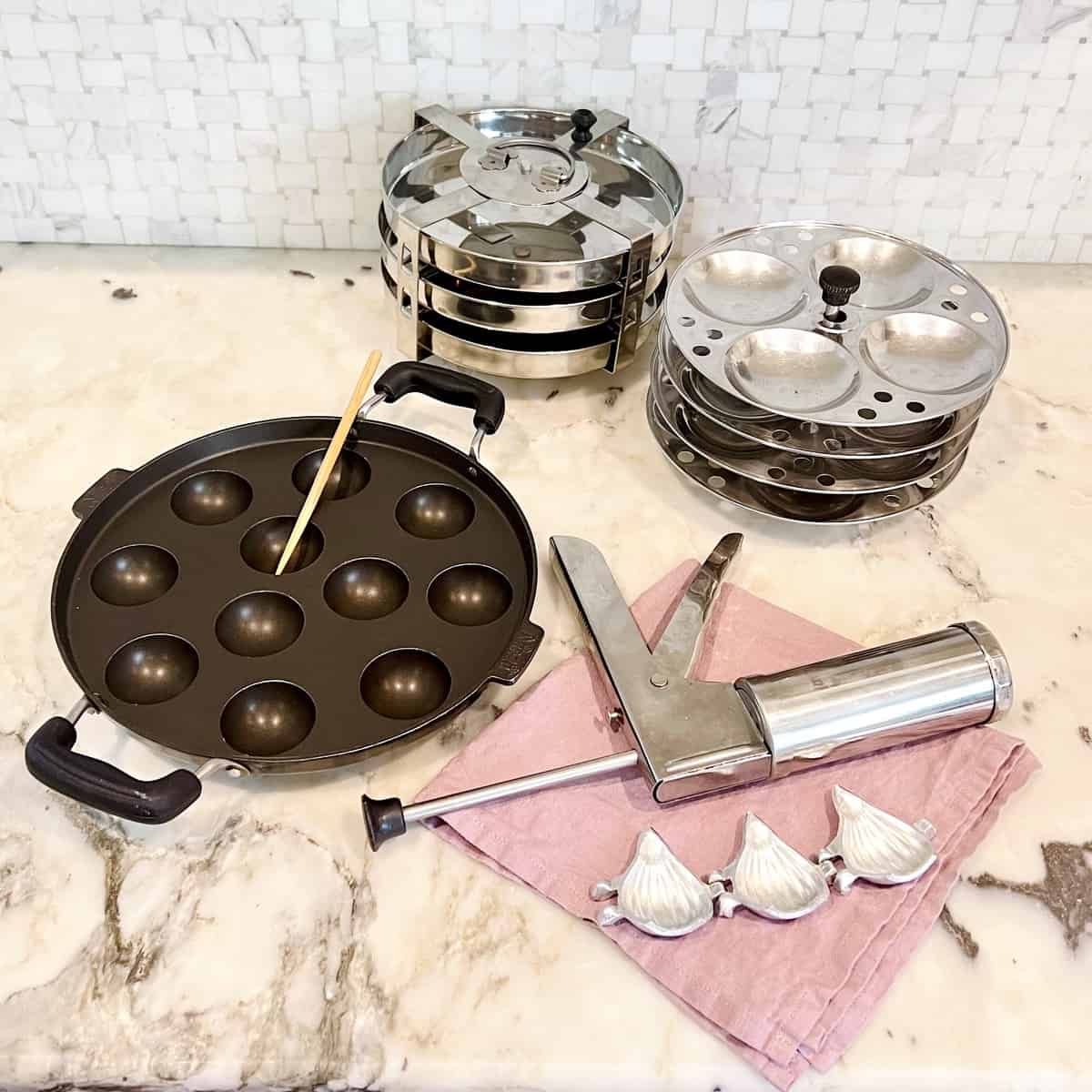 Indian cooking tools - appe pan, modak mold, chakli press, idli and dhokla stand 