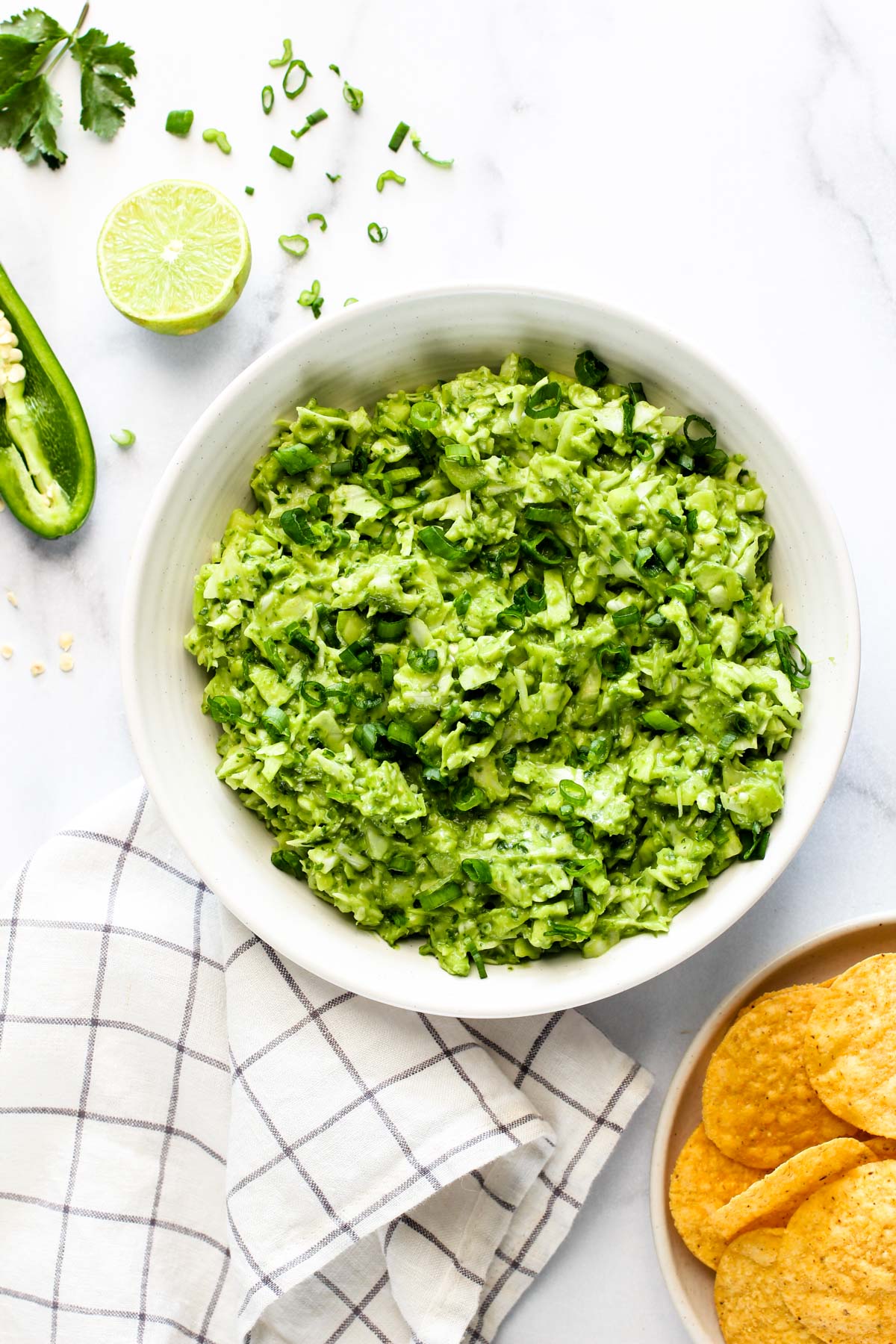 green goddess salad in a white bowl served with chips