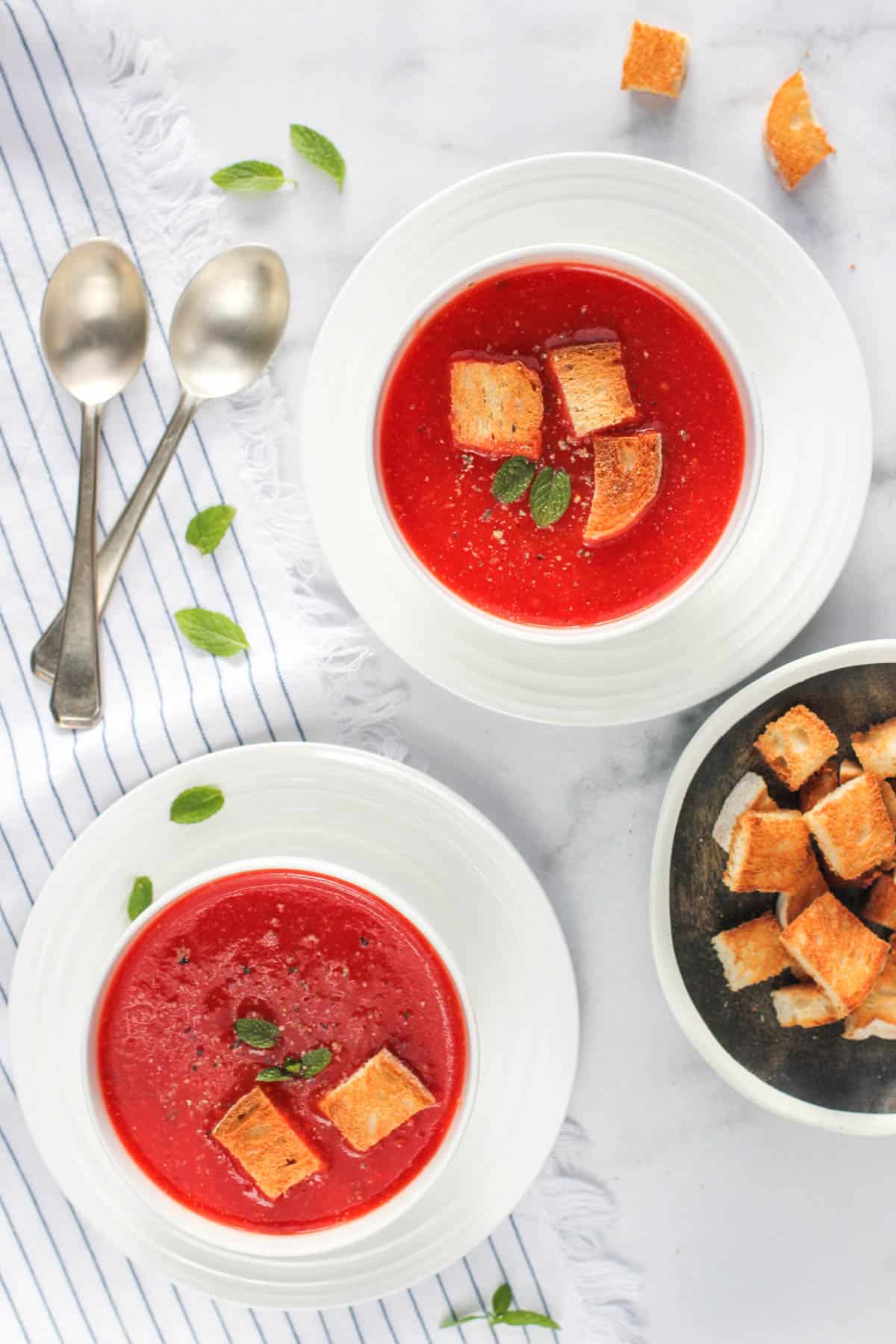 Tomato Beet Soup served in white bowls with croutons