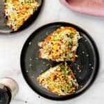 avocado egg toast served on a black plate