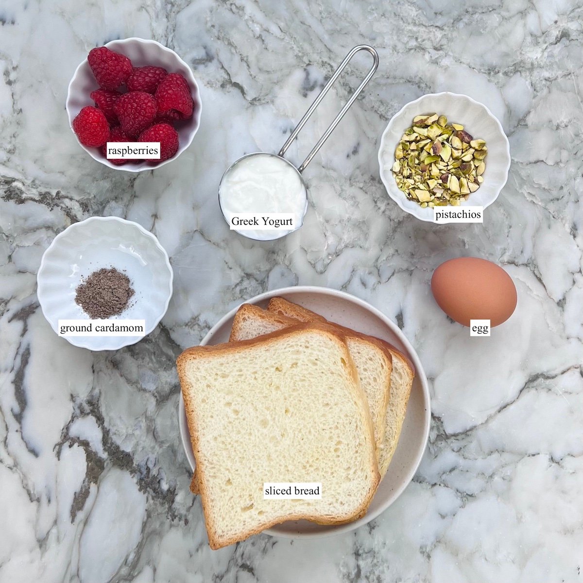 Ingredients to make yogurt toast - berries, greek yogurt, bread, egg 