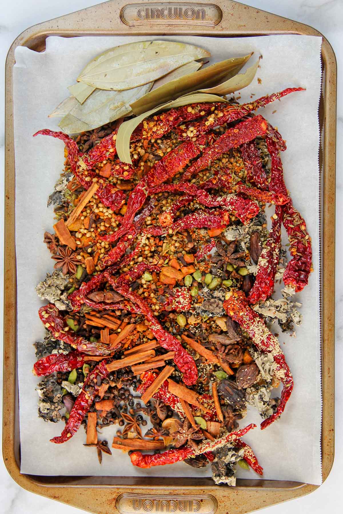 Roasted whole spices in a baking tray 